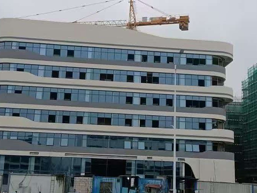 Six-storey manufacturing and office building with curved ribbon window bands